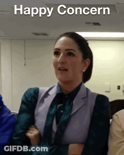 Woman In Suit And Tie Saying Happy Concern GIF