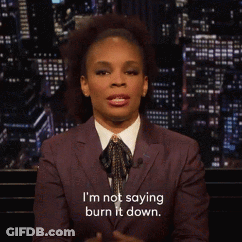 Woman In Suit And Tie Saying I'm Not Saying Burn It Down GIF