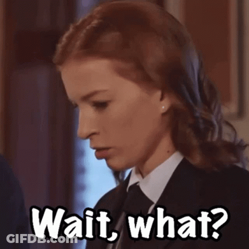 Woman In Suit And Tie Saying Wait What GIF