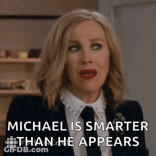 Woman In Suit And Tie Says Michael Is Smarter Than He Appears GIF