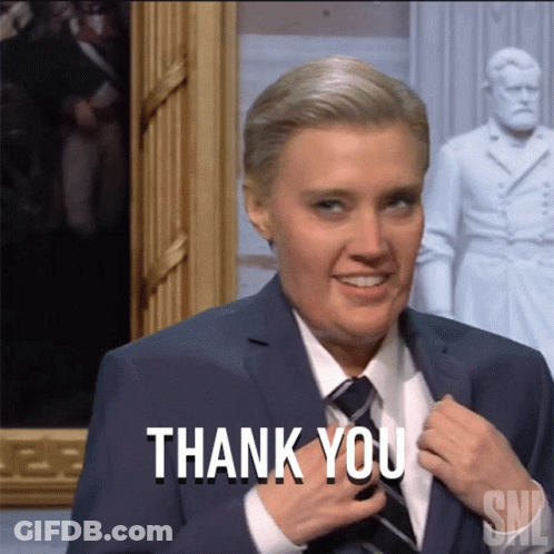 Woman In Suit And Tie Smiling Thank You GIF