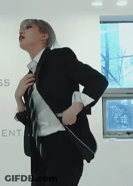 Woman In Suit Beside Wall Saying SS GIF