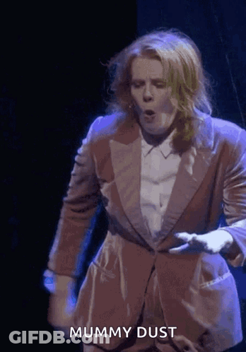 Woman In Suit Dancing Mummy Dust GIF