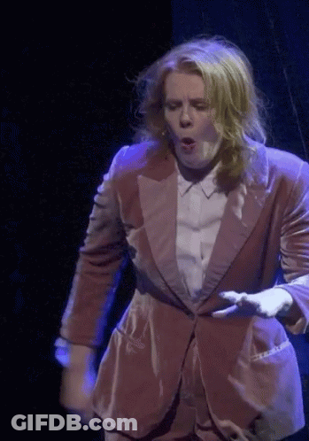 Woman In Suit Dancing On Stage GIF