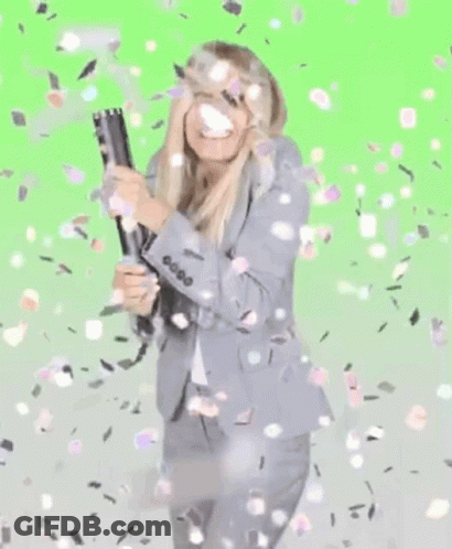 Woman In Suit Holding Cannon With Confetti GIF