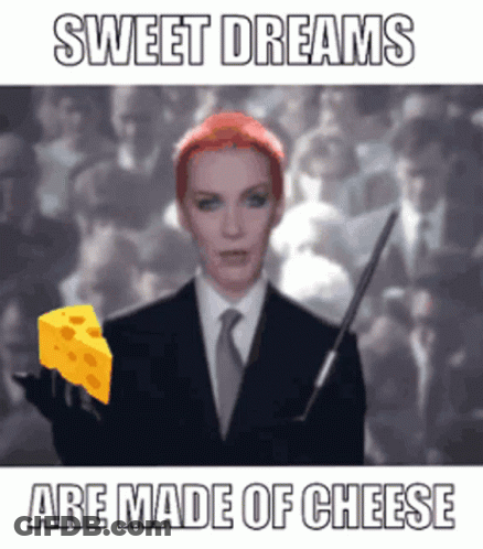 Woman In Suit Holding Cheese Sweet Dreams Are Made Of Cheese GIF