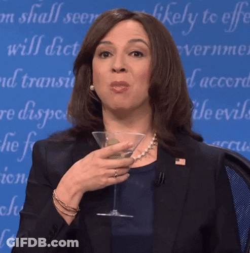 Woman In Suit Holding Martini Glass Saying Likely To Effect GIF
