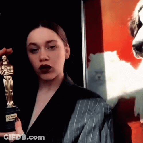 Woman In Suit Holding Oscar And Dog Photo GIF
