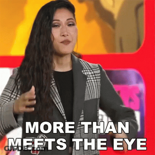 Woman In Suit In Front Of Red Sign More Than Meets The Eye GIF