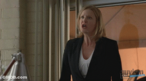 Woman In Suit In Front Of Window With Guyson Watermark GIF