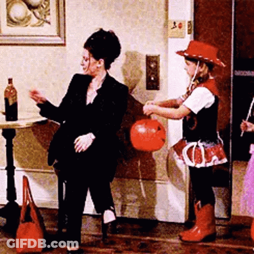 Woman In Suit Next To Girl In Cowboy Costume GIF