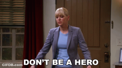 Woman In Suit Saying Don't Be A Hero GIF