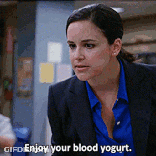 Woman In Suit Saying Enjoy Your Blood Yogurt GIF