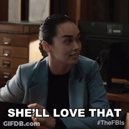 Woman In Suit Saying She'll Love That On A Screen GIF
