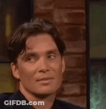 Woman In Suit Says Cross My Heart In Front Of Door GIF