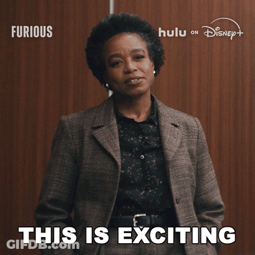 Woman In Suit Says This Is Exciting In Front Of Disney Logo GIF