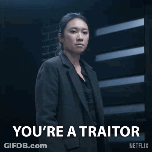 Woman In Suit Says You're A Traitor GIF