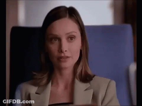 Woman In Suit Sitting In Blue Chair On Plane GIF