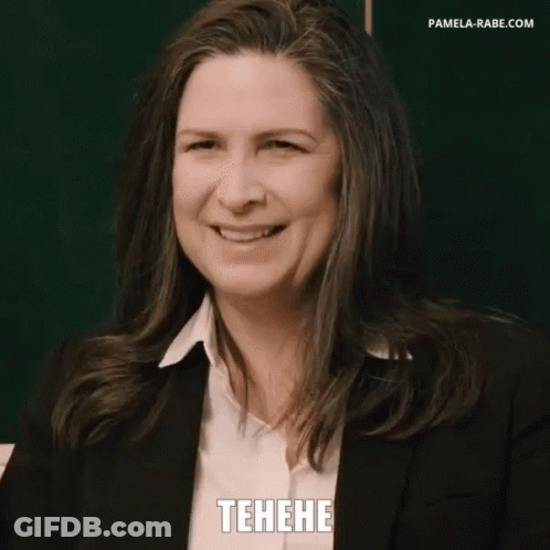Woman In Suit Smiling In Front Of Blackboard GIF