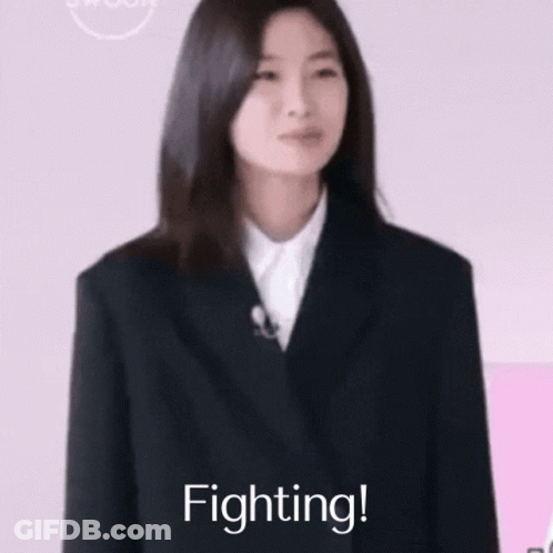 Woman In Suit Smiling With Fist Up Saying Fighting GIF