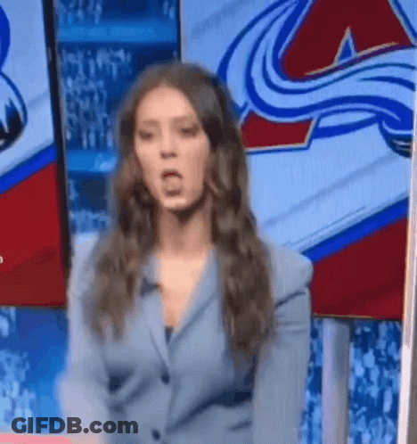 Woman In Suit Standing Before Hockey Logo GIF