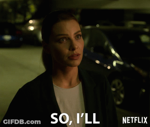 Woman In Suit Standing Before Netflix Sign GIF