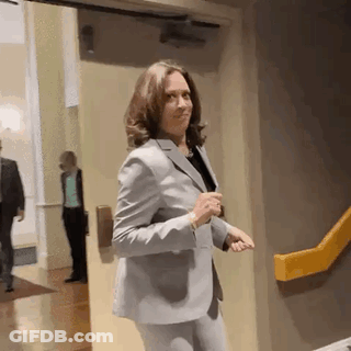 Woman In Suit Standing By Yellow Railing GIF