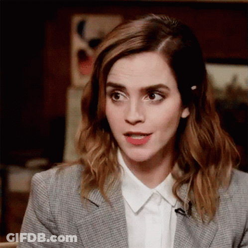 Woman In Suit Talking On Microphone With Funny Face GIF