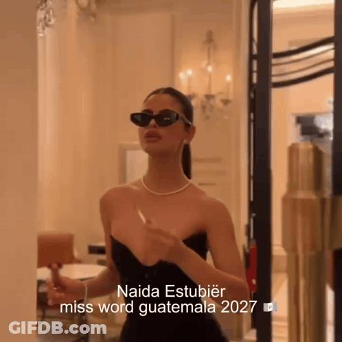 Woman In Sunglasses And Black Dress Saying Naida Estubier Miss Word Guatemala 2027 GIF