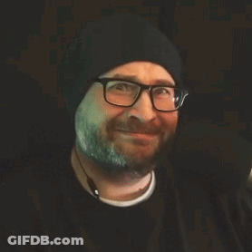 Woman In Sunglasses And Black Jacket Gesturing At Mirror GIF
