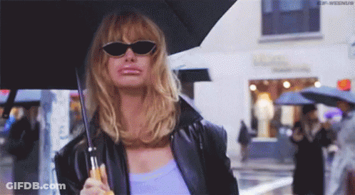 Woman In Sunglasses And Black Jacket Holding Umbrella In Rain GIF