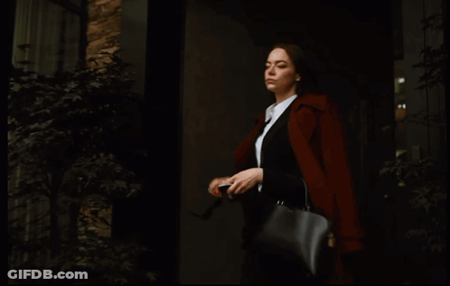 Woman In Sunglasses And Black Purse Looking At Phone GIF