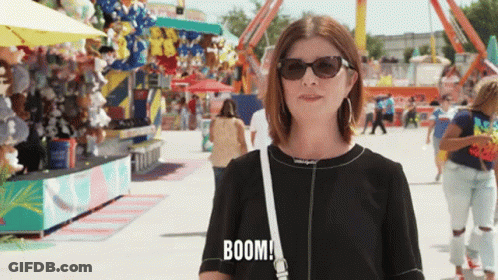 Woman In Sunglasses And Black Shirt Saying Boom GIF