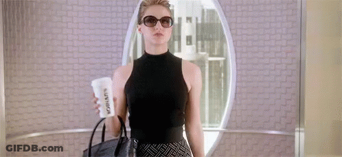 Woman In Sunglasses And Black Top Holding Coffee And Purse GIF