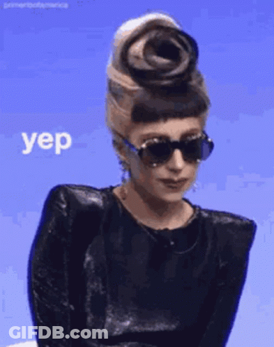 Woman In Sunglasses And Black Top With Flower Saying Yep GIF