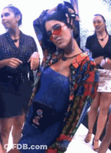 Woman In Sunglasses And Blue Dress Standing Next To Group Of Women GIF