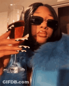 Woman In Sunglasses And Blue Jacket Holding Wine GIF