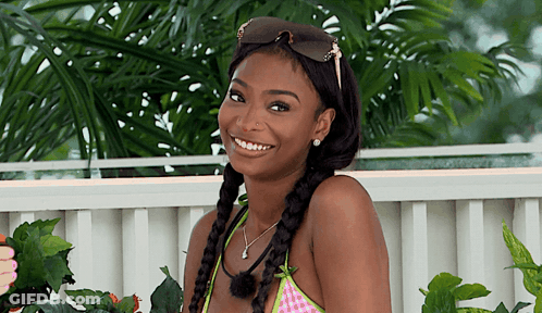 Woman In Sunglasses And Braided Hair Smiling GIF