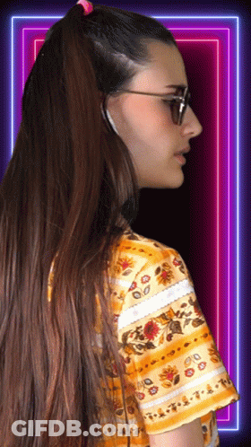 Woman In Sunglasses And Floral Shirt Looking Sideways GIF