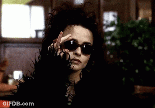 Woman In Sunglasses And Fur Coat Making Peace Sign GIF