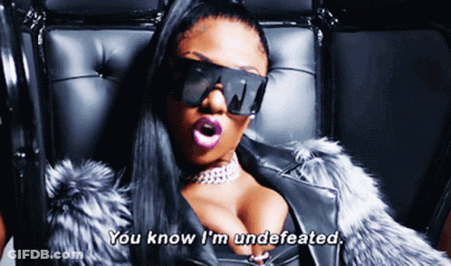Woman In Sunglasses And Fur Coat Saying You Know I'm Undefeated GIF