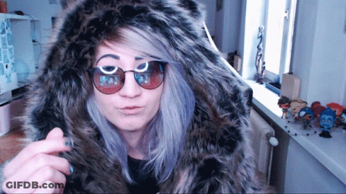 Woman In Sunglasses And Fur Hood At Window GIF
