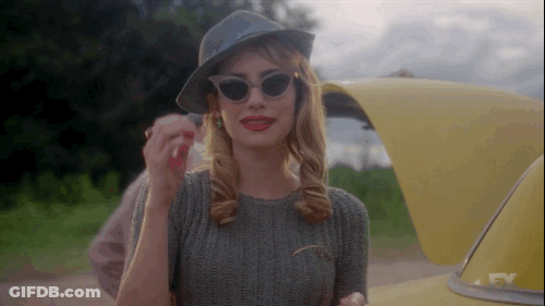 Woman In Sunglasses And Hat Next To Yellow Car GIF