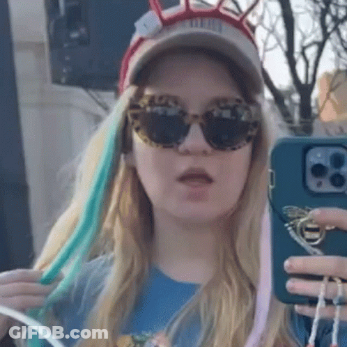 Woman In Sunglasses And Hat Taking Selfie GIF
