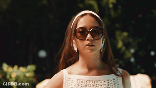 Woman In Sunglasses And Headband Looking To Side GIF