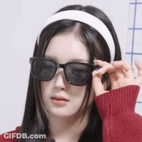 Woman In Sunglasses And Headband Making A Face GIF