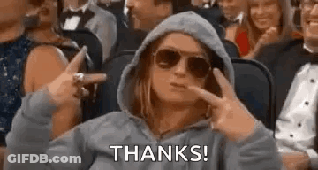 Woman In Sunglasses And Hoodie Sitting In Crowd GIF