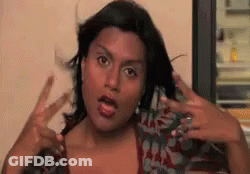 Woman In Sunglasses And Hoodie Sitting In Crowd GIF