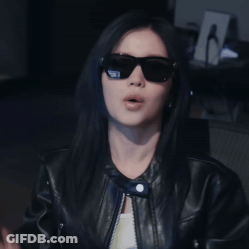 Woman In Sunglasses And Leather Jacket Making Funny Face GIF