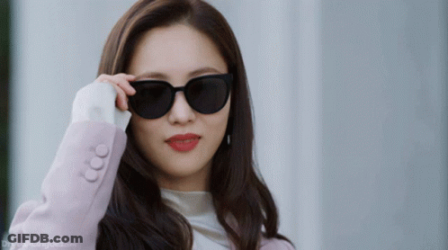 Woman In Sunglasses And Pink Jacket Drfreemangook.com GIF